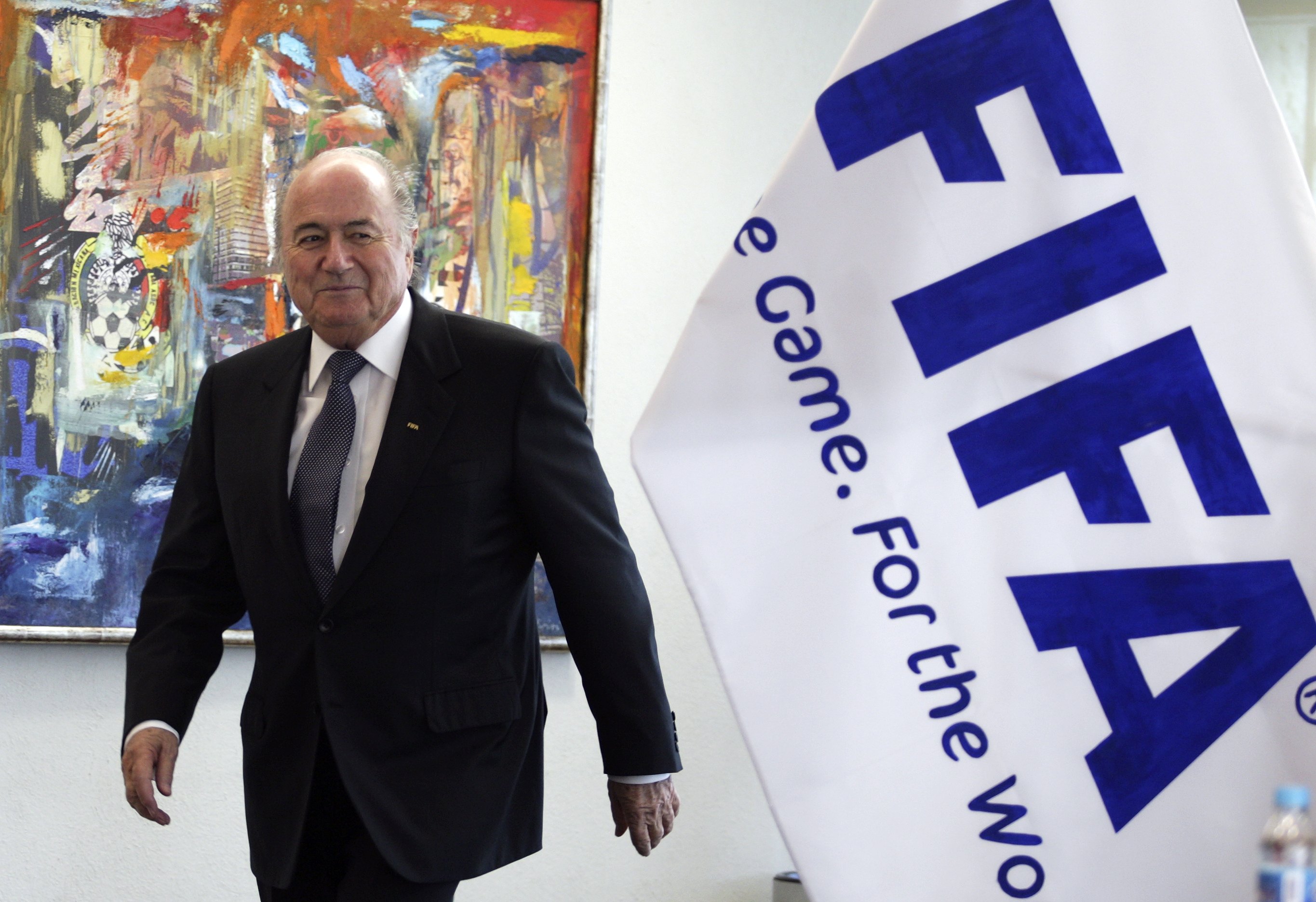 Sepp_Blatter_in_front_of_FIFA_flag